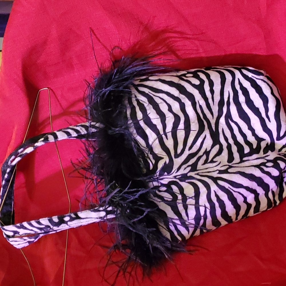 Black and white Zebra purse with feathers around the top